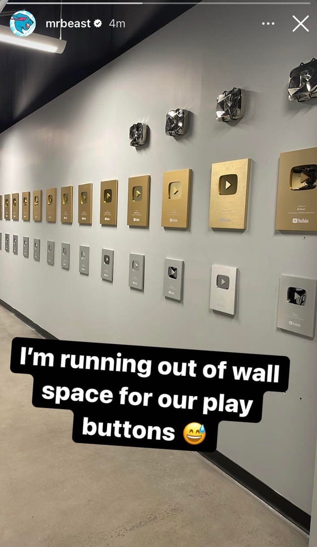 The full play-button wall — one plaque per subscriber milestone.